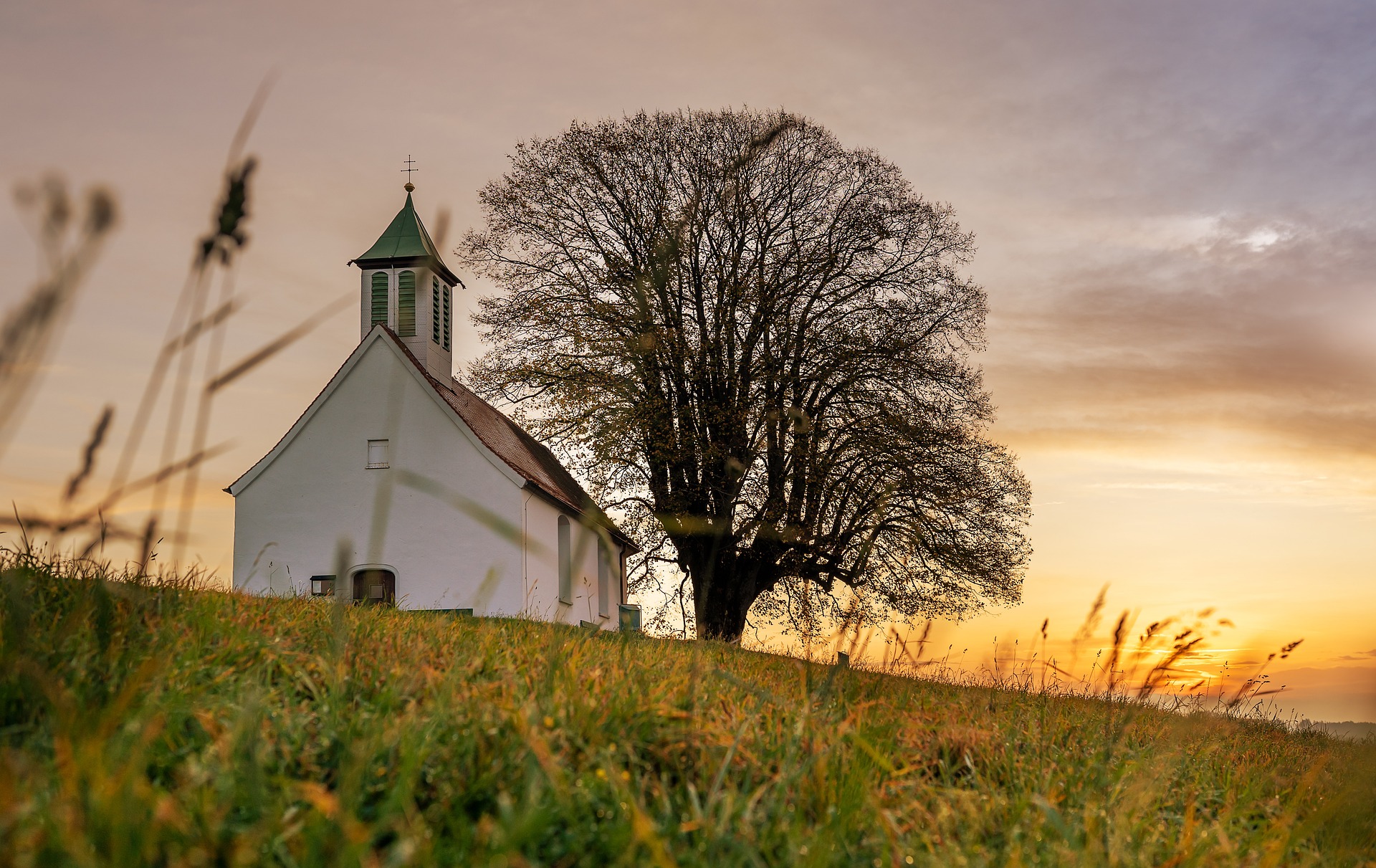 church with sunrise or sunset and large tree