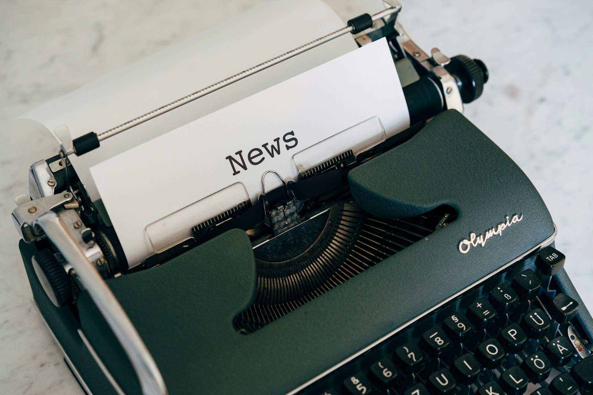 typewriter with "news" on paper